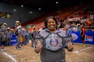 Woman holding champion belt